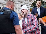 London, United Kingdom. 20th October 2014 -- Police talking to Brian Harvey former East 17 singer outside the gates of 10 Downing Street. Harvey demanded to see the Prime Minister. -- Police were called when Brian Harvey, former East 17 singer, stood outside the gates of 10 Downing Street, demanding to see the Prime Minister. Harvey, a victim of News of the World phone hacking demanded that the Prime Minister look into his 'case'.