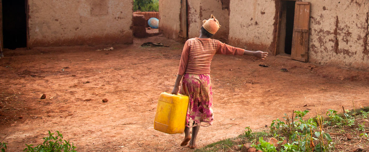 A woman carries a jerry can of water to her home in Alakamisy, Madagascar. 